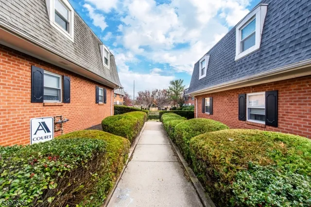 a view of a brick house with a yard