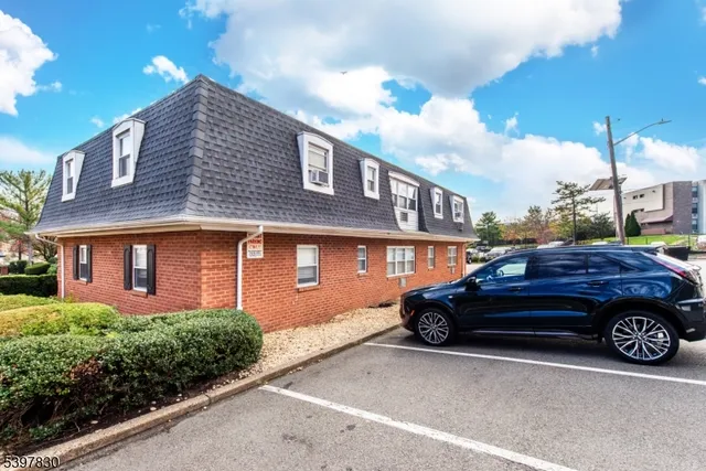 a front view of a house with parking space