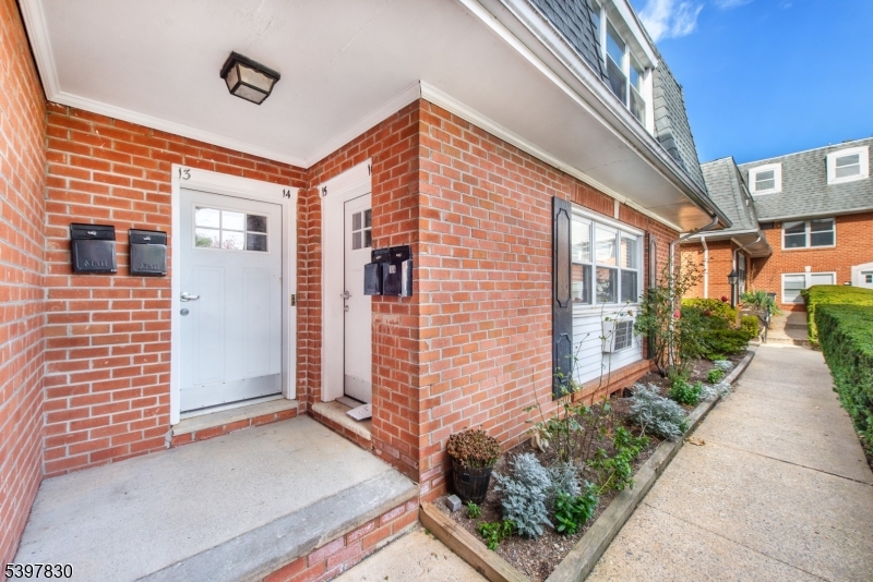 25 River Road, Unit A14 Nutley, NJ 07110 - Photo 3 of 21 a view of a brick house with many windows