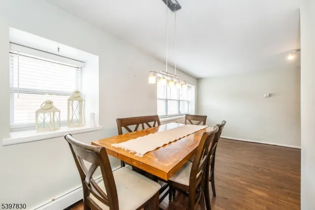 a view of a dining room with furniture and windows
