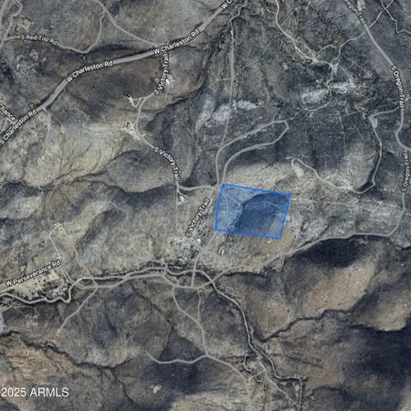 a view of a field with a tree in the background