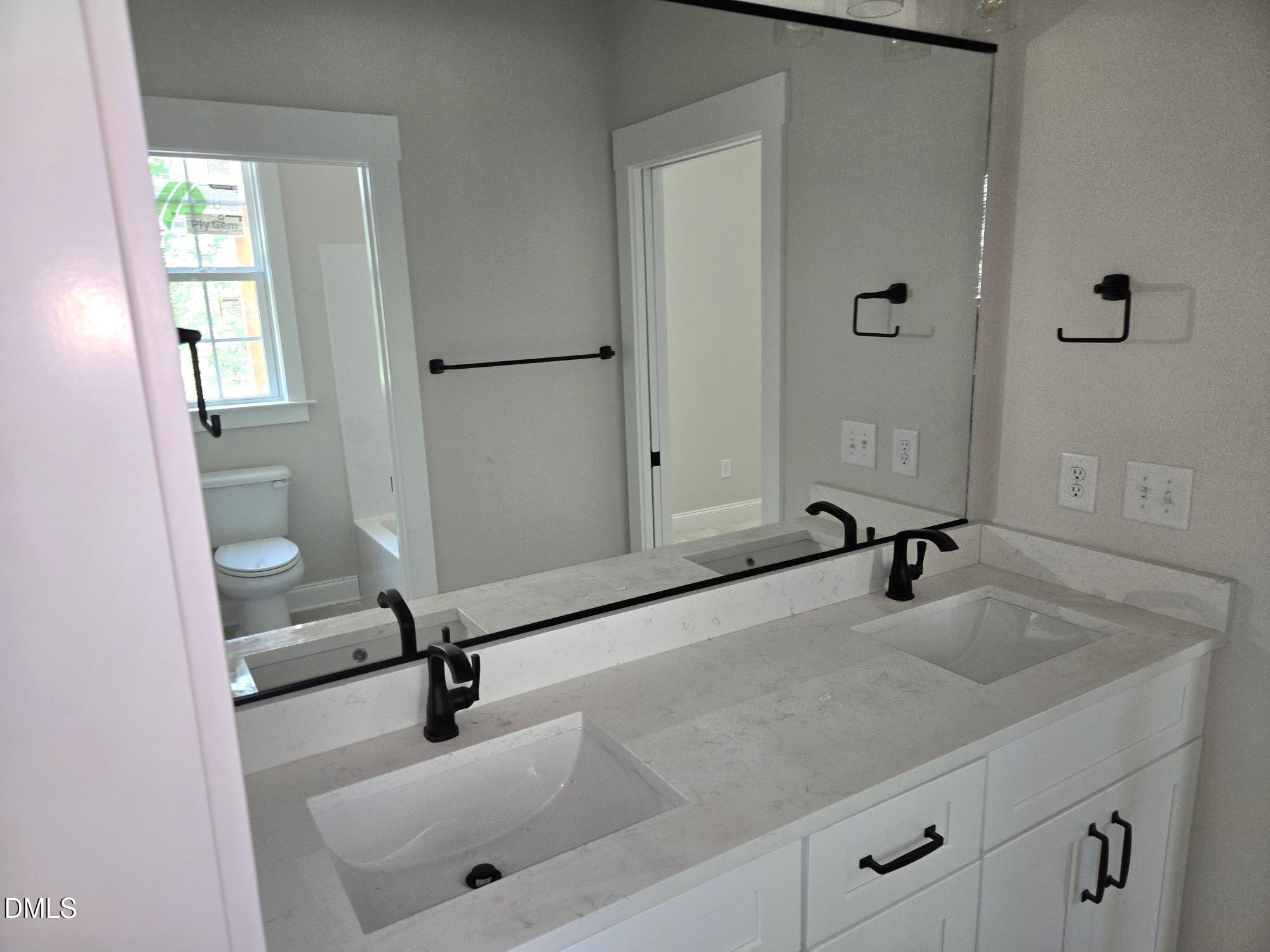 300 Avery Road Erwin, NC 28339 - Photo 14 of 38 a bathroom with a sink and a mirror