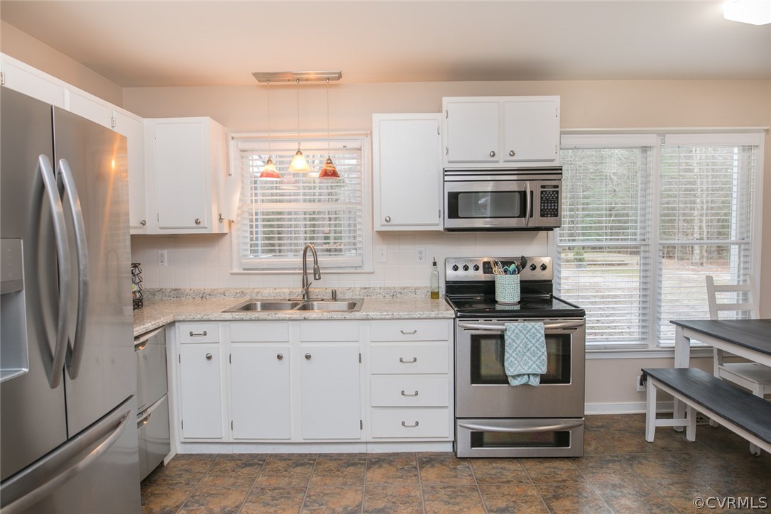 11631 Beach Road Chesterfield, VA 23838 - Photo 18 of 49 a kitchen with stainless steel appliances granite countertop a stove a sink and a microwave