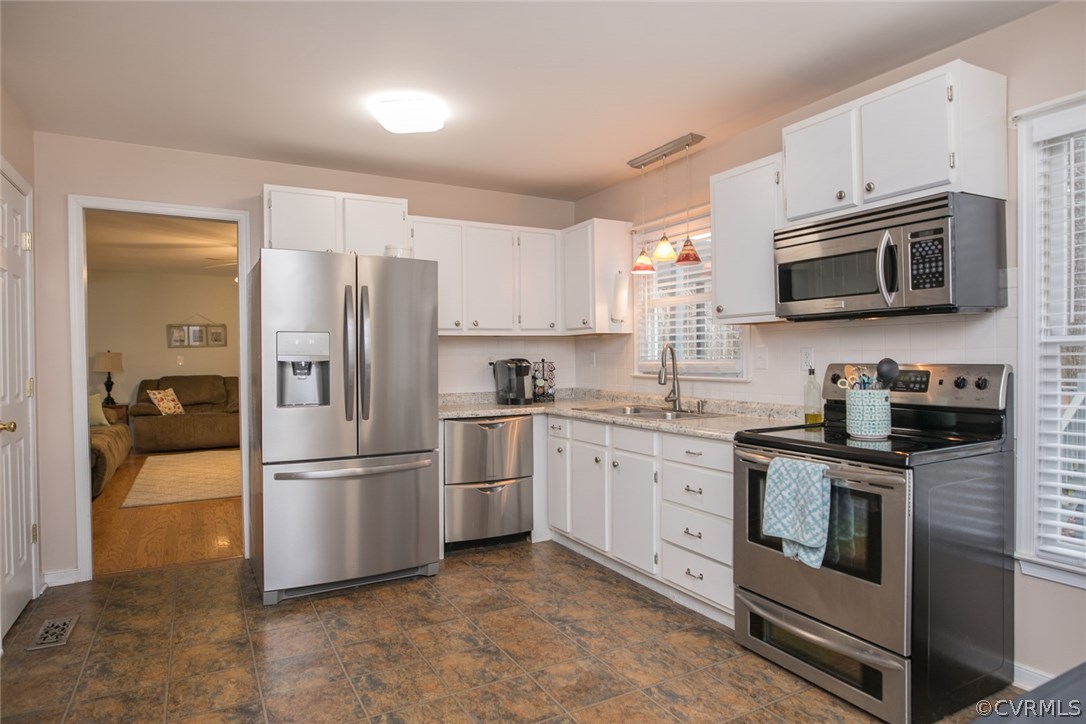 11631 Beach Road Chesterfield, VA 23838 - Photo 20 of 49 a kitchen with granite countertop a refrigerator stove and microwave