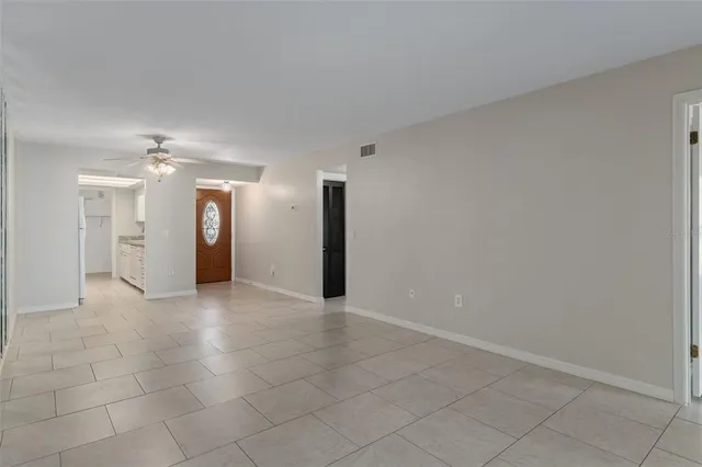 a kitchen with granite countertop white cabinets and a sink