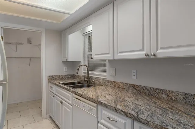 a kitchen with a sink a stove and refrigerator