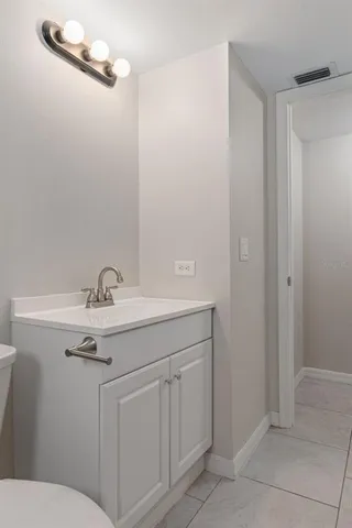 a bathroom with a shower sink vanity and mirror