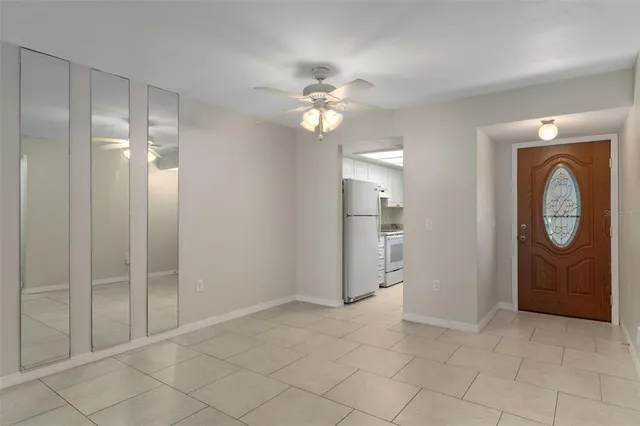 a view of an empty room and cabinet with wooden floor
