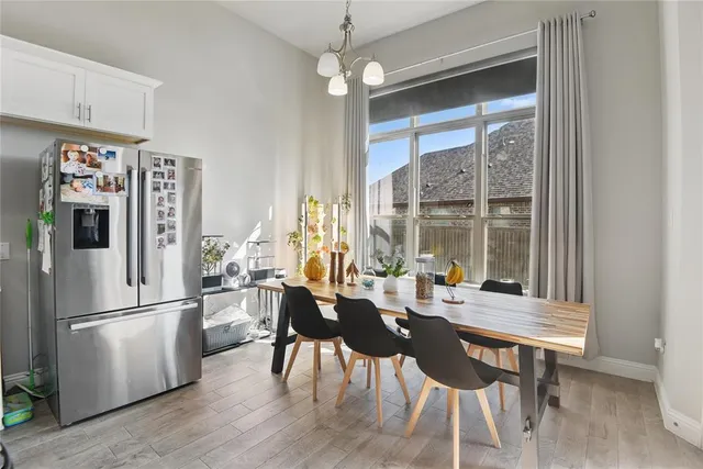 a view of a dining room with furniture large window and wooden floor