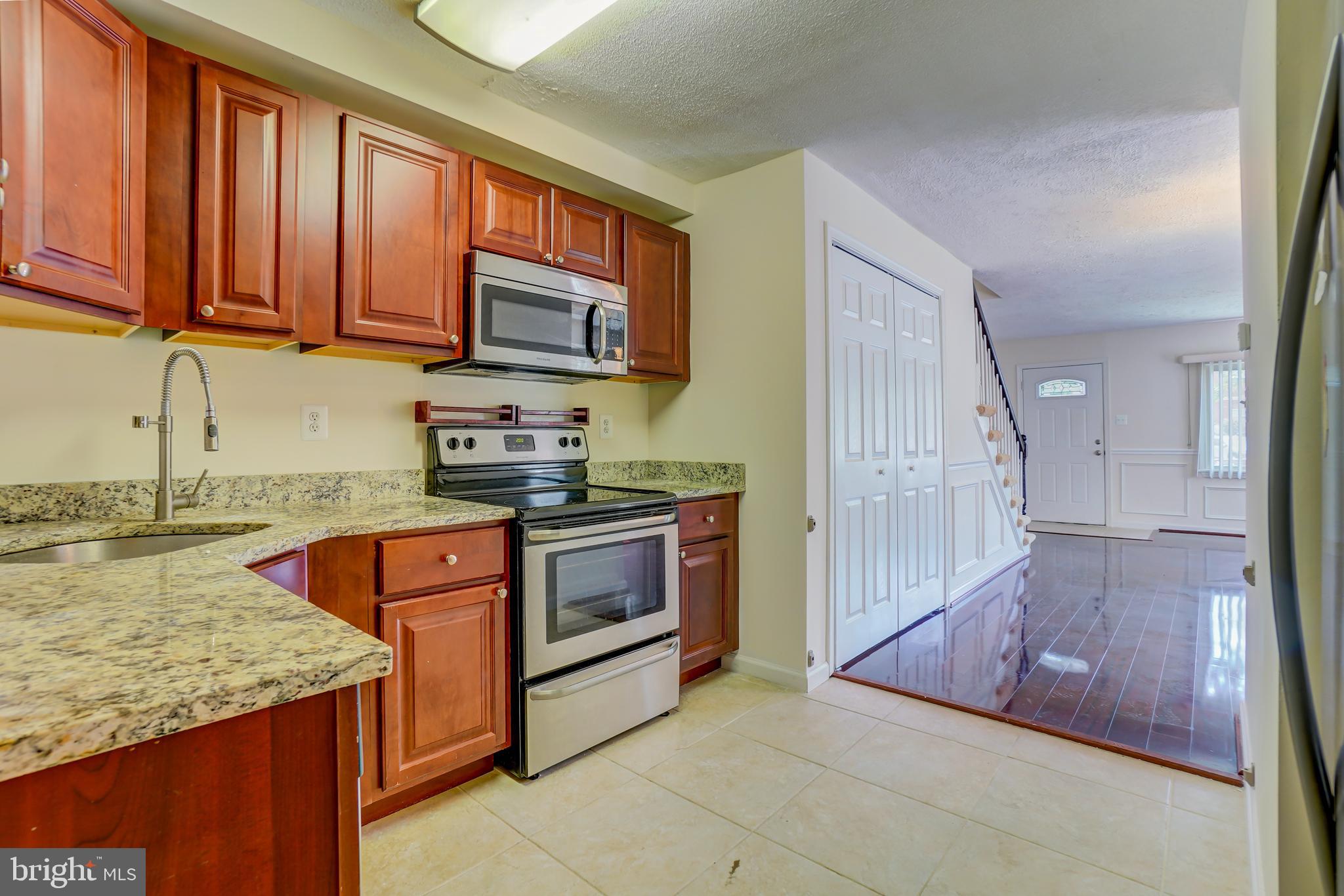 628 Four Mile Road Alexandria, VA 22305 - Photo 9 of 29 a kitchen with stainless steel appliances granite countertop a stove a sink and a microwave