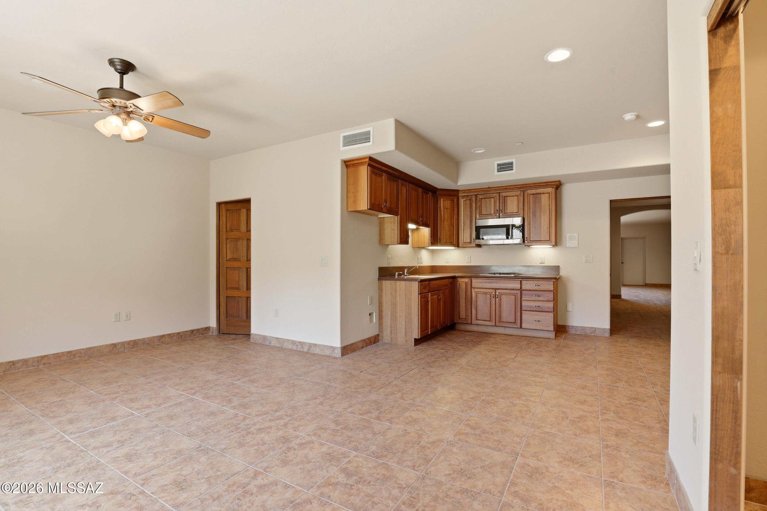 6331 West Trails End Road Tucson, AZ 85745 - Photo 25 of 41 a view of a kitchen with a sink cabinets and entryway