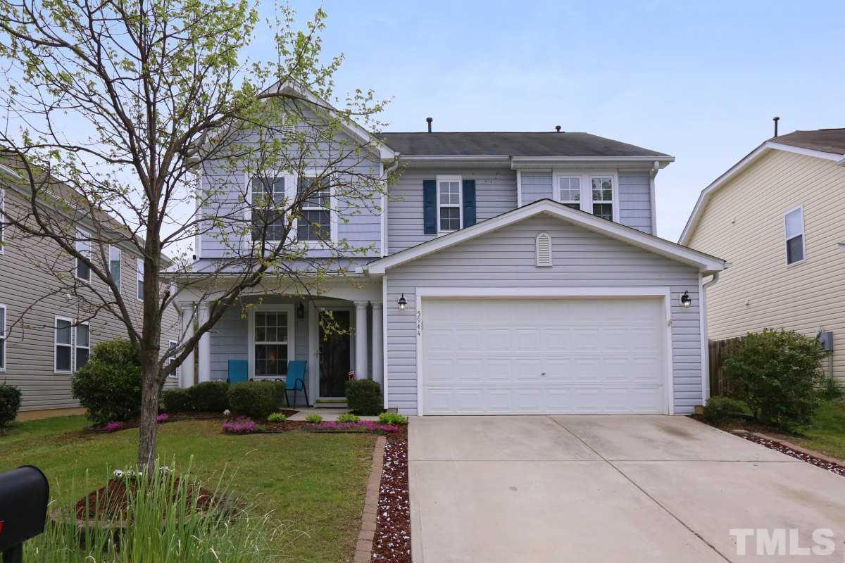 5944 Ricker Road Raleigh, NC 27610 - Photo 1 of 25 a front view of a house with a yard and garage