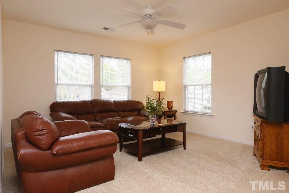 5944 Ricker Road Raleigh, NC 27610 - Photo 14 of 25 a living room with furniture and a flat screen tv