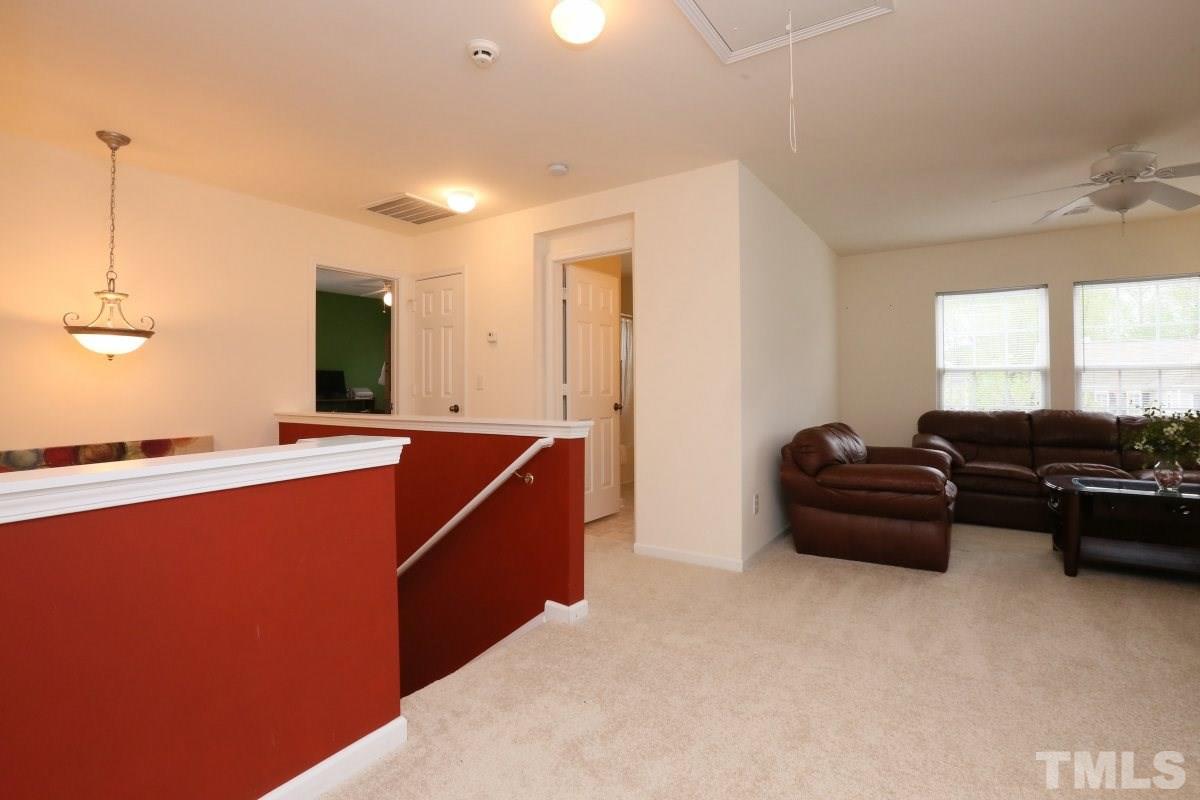 5944 Ricker Road Raleigh, NC 27610 - Photo 15 of 25 a living room with furniture and a flat screen tv