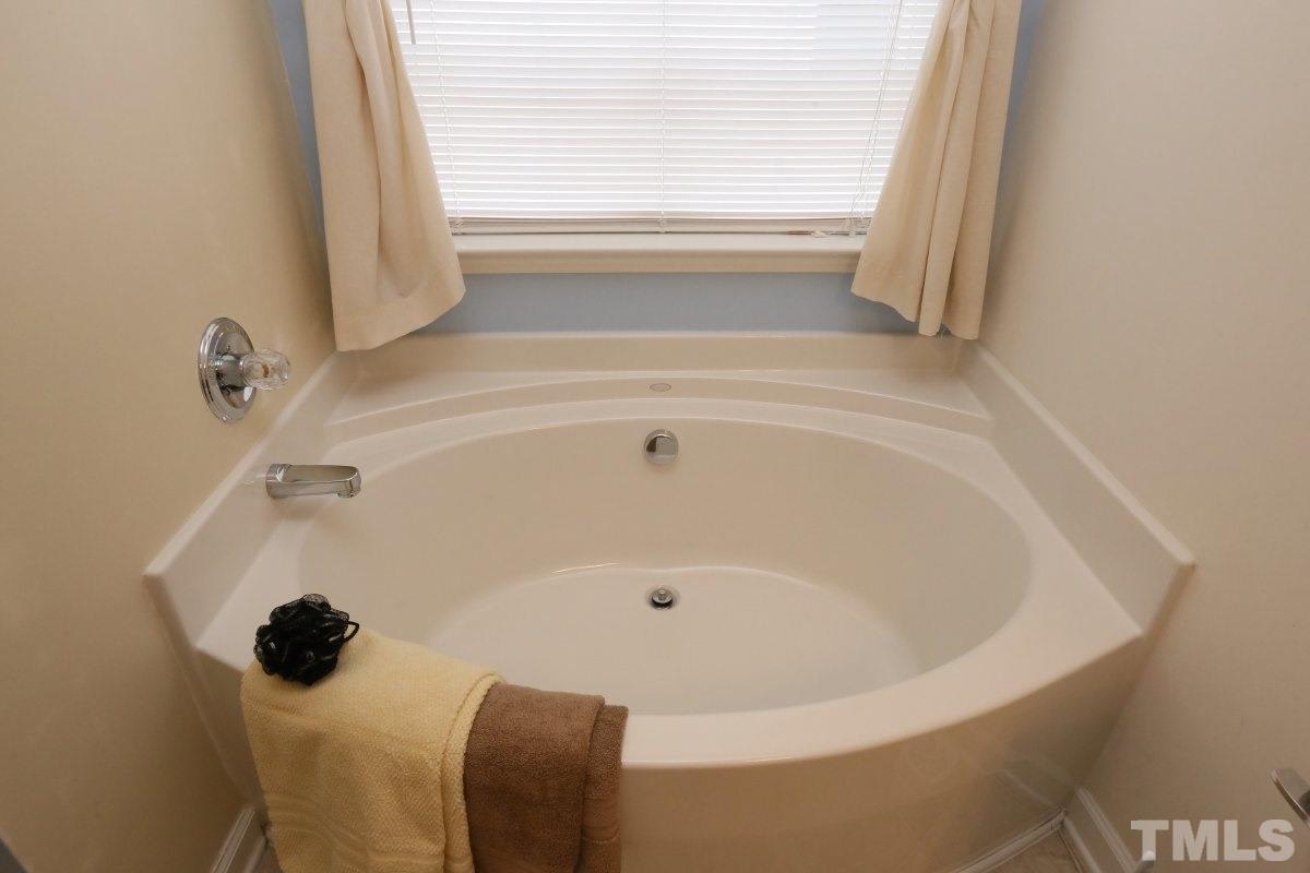 5944 Ricker Road Raleigh, NC 27610 - Photo 18 of 25 a bathroom with a tub