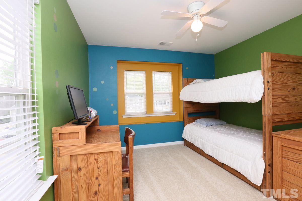 5944 Ricker Road Raleigh, NC 27610 - Photo 21 of 25 a bedroom with a bed window and chair