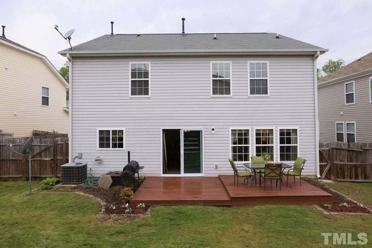 5944 Ricker Road Raleigh, NC 27610 - Photo 22 of 25 a view of backyard of house with outdoor seating and slide