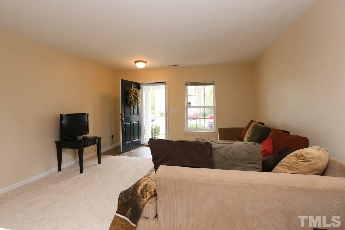 5944 Ricker Road Raleigh, NC 27610 - Photo 8 of 25 a living room with a couch and a window
