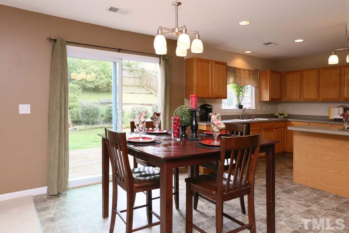 5944 Ricker Road Raleigh, NC 27610 - Photo 10 of 25 a view of a dining room with furniture window and outside view