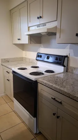a kitchen with stainless steel appliances granite countertop a sink stove and cabinets