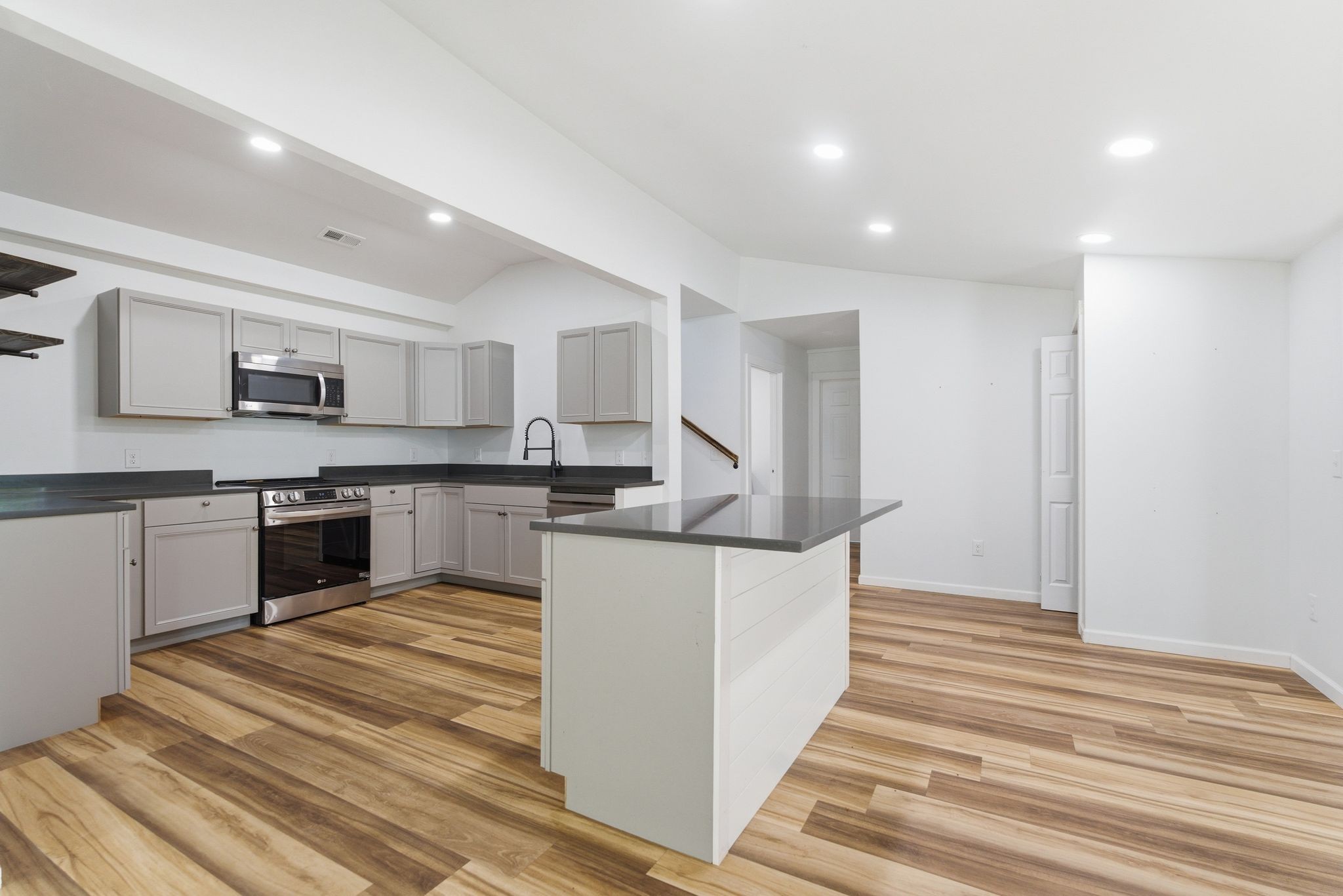 2635 McBrides Branch Road Beechgrove, TN 37018 - Photo 13 of 48 a kitchen with stainless steel appliances kitchen island granite countertop a refrigerator and a stove top oven