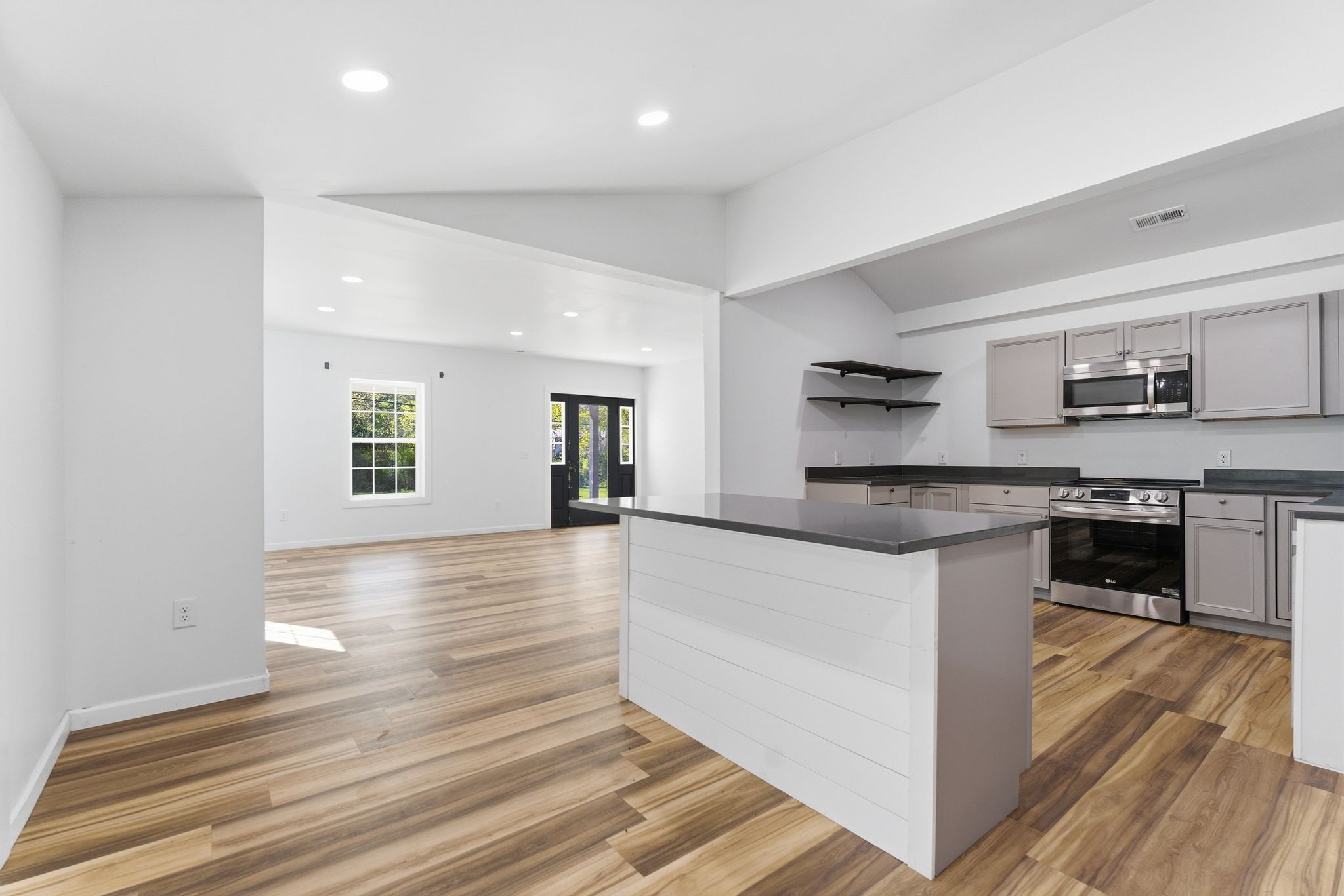 2635 McBrides Branch Road Beechgrove, TN 37018 - Photo 15 of 48 a kitchen with stainless steel appliances granite countertop a sink and stove top oven
