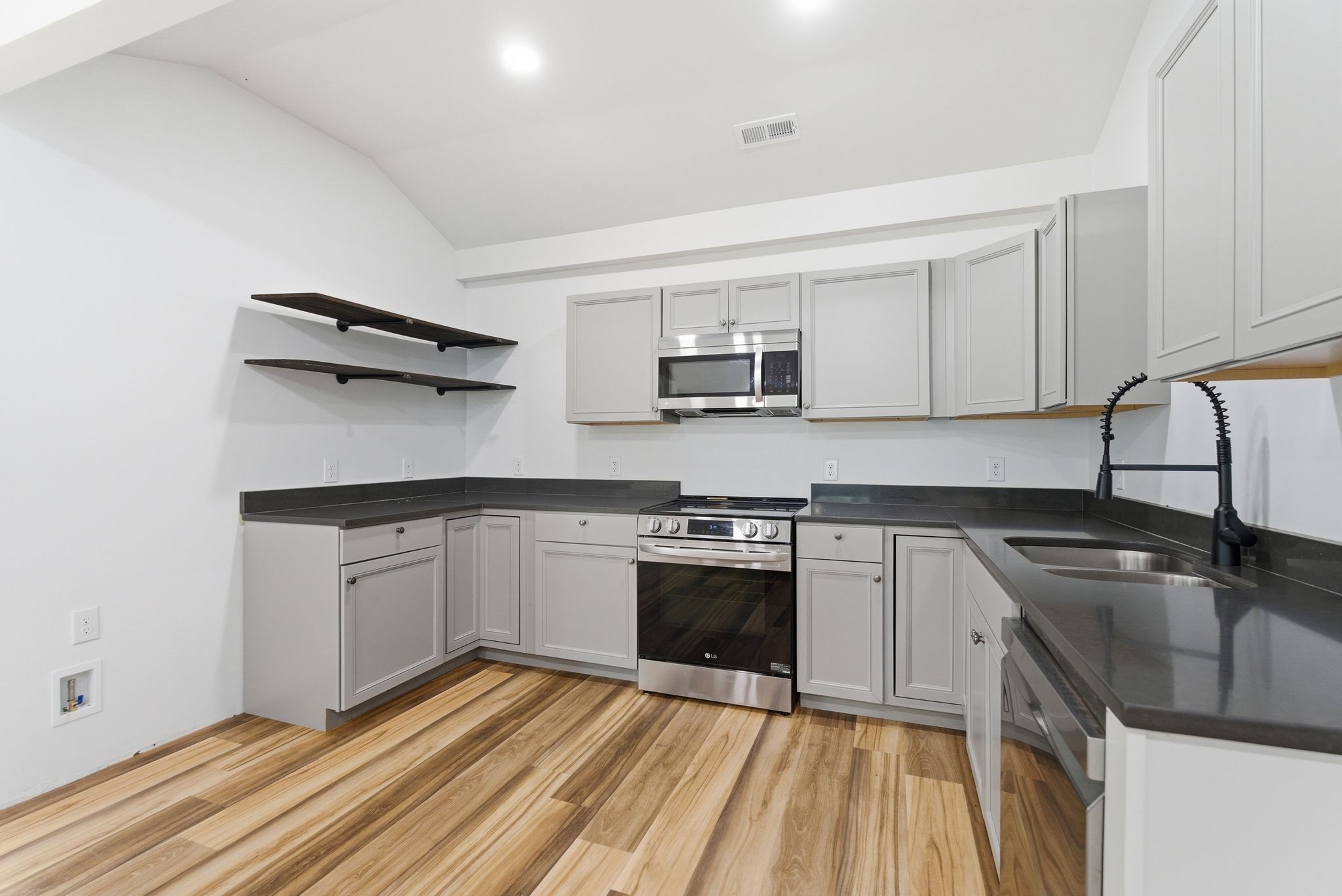 2635 McBrides Branch Road Beechgrove, TN 37018 - Photo 16 of 48 a kitchen with kitchen island granite countertop a sink stove and microwave