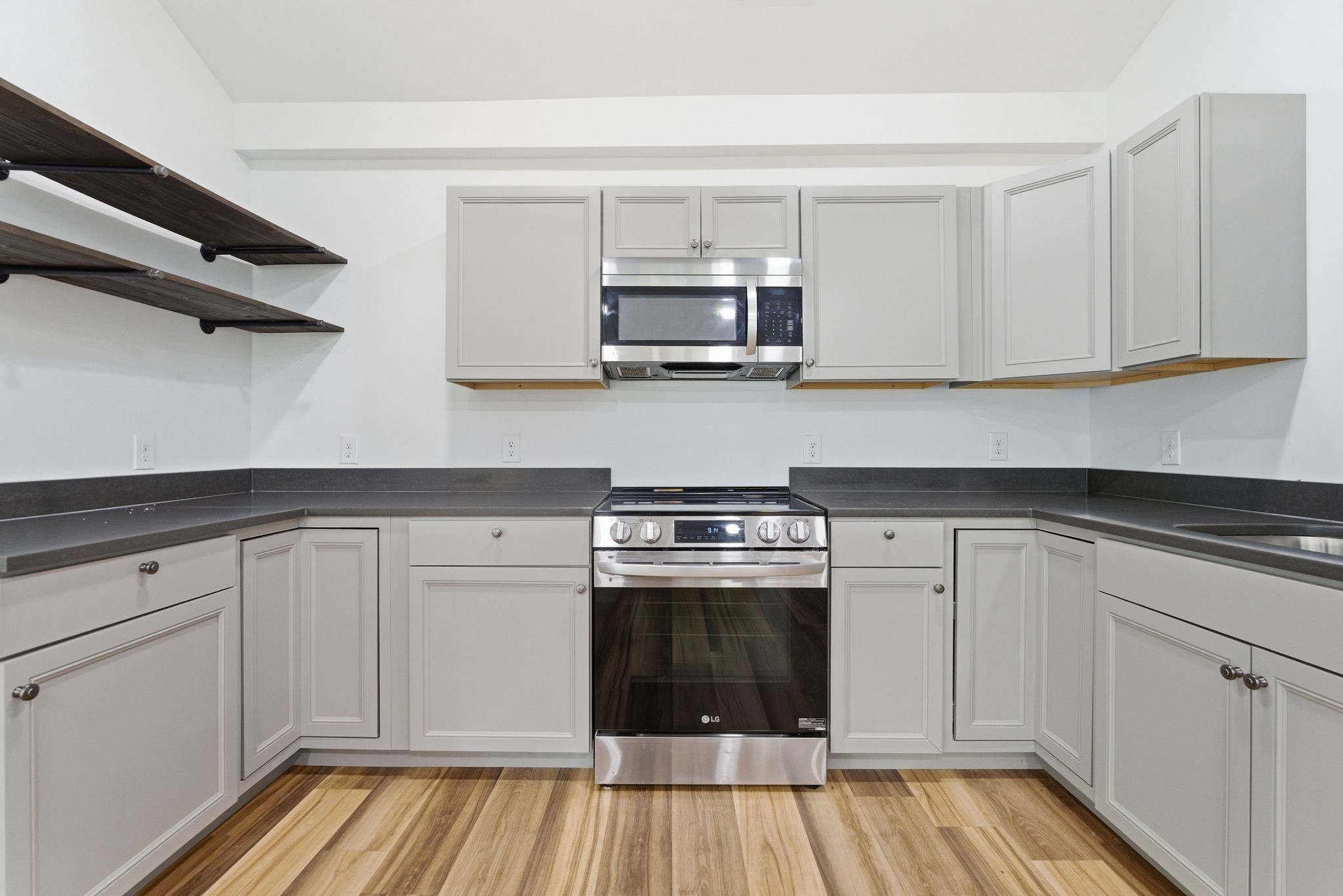2635 McBrides Branch Road Beechgrove, TN 37018 - Photo 17 of 48 a kitchen with stainless steel appliances granite countertop a stove and white cabinets