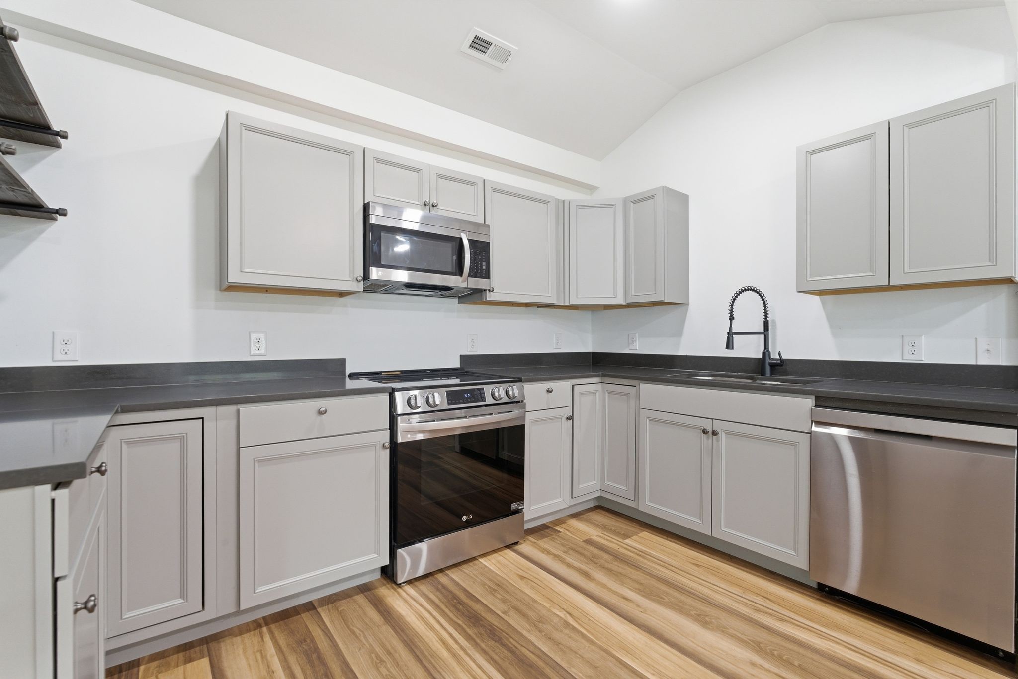 2635 McBrides Branch Road Beechgrove, TN 37018 - Photo 18 of 48 a kitchen with stainless steel appliances granite countertop a stove a sink and a microwave