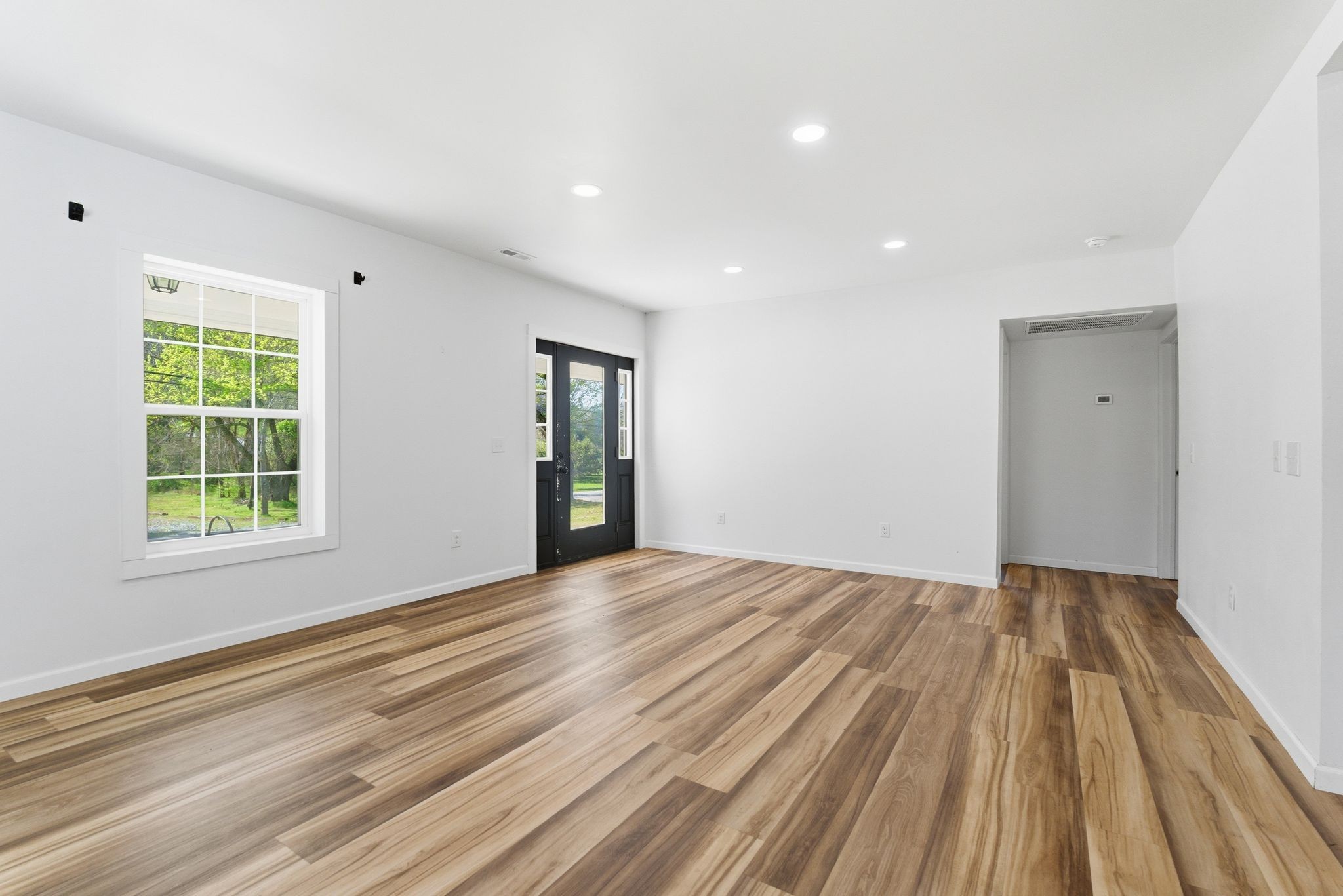 2635 McBrides Branch Road Beechgrove, TN 37018 - Photo 9 of 48 a view of an empty room with wooden floor and a window