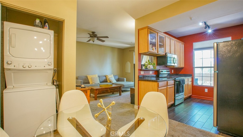 375 Central Avenue, Unit 153 Riverside, CA 92507 - Photo 11 of 24 a dining room with stainless steel appliances a refrigerator a table and chairs