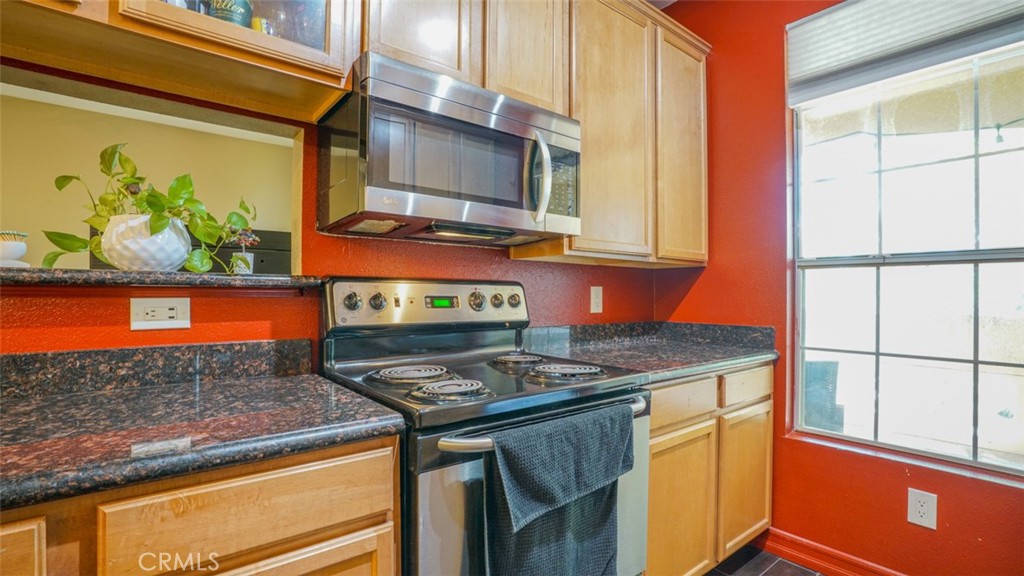 375 Central Avenue, Unit 153 Riverside, CA 92507 - Photo 15 of 24 a kitchen with stainless steel appliances granite countertop a stove a sink and a microwave
