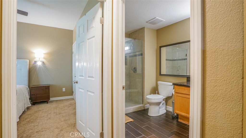 375 Central Avenue, Unit 153 Riverside, CA 92507 - Photo 20 of 24 a bathroom with a granite countertop toilet and a shower