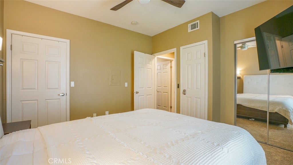 375 Central Avenue, Unit 153 Riverside, CA 92507 - Photo 22 of 24 a bedroom with a bed and a view of living room