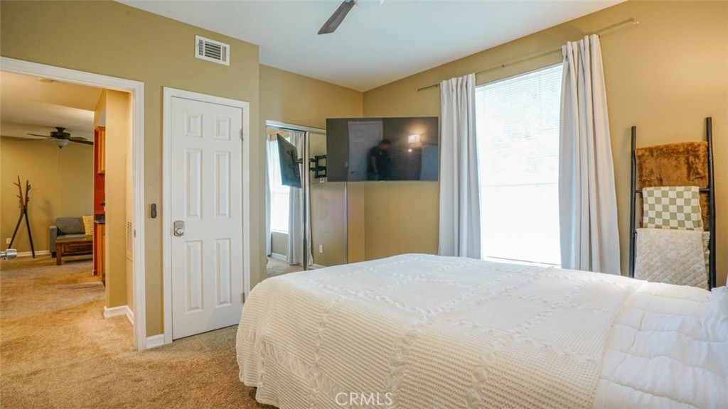 375 Central Avenue, Unit 153 Riverside, CA 92507 - Photo 23 of 24 a bedroom with a bed and a chandelier