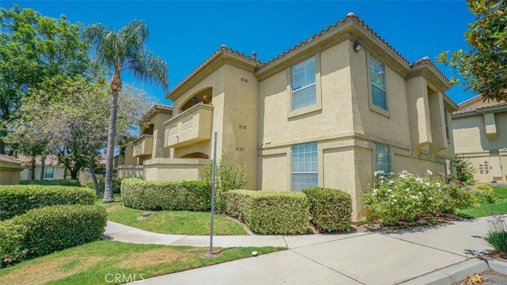 375 Central Avenue, Unit 153 Riverside, CA 92507 - Photo 3 of 24 a front view of a house with a yard