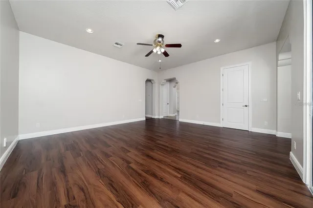 a view of a hallway with cabinets