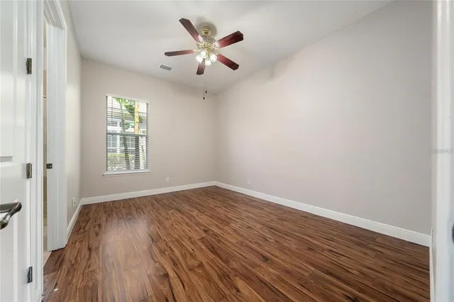 a view of an empty room with wooden floor
