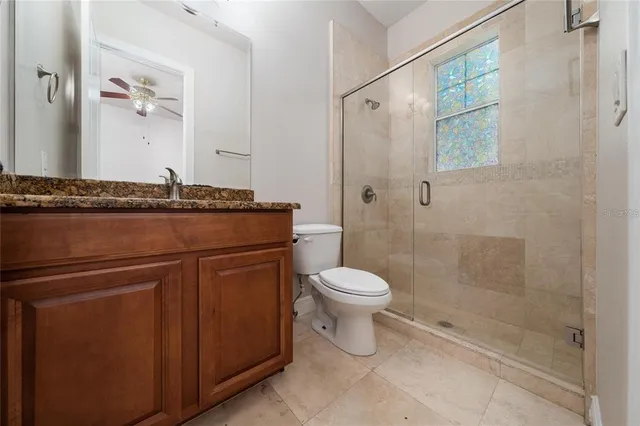 a kitchen with stainless steel appliances granite countertop wooden floors wooden cabinets and a window