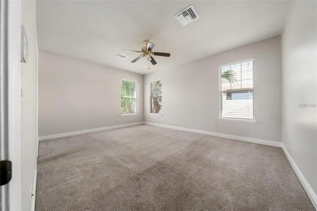 a spacious bathroom with a tub sink and mirror