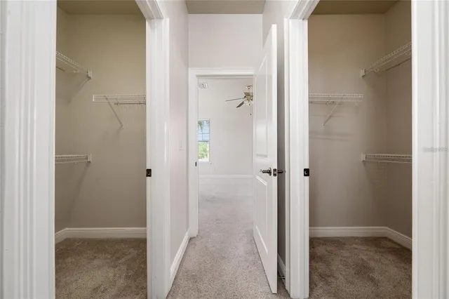 an empty room with a ceiling fan and a window