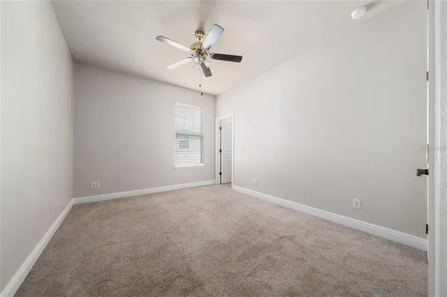 a bathroom with a granite countertop toilet a sink and a mirror