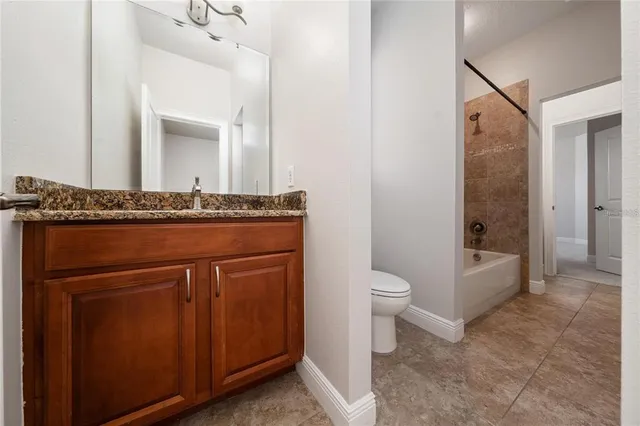 an empty room with chandelier fan