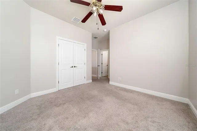 a view of house with backyard and glass windows
