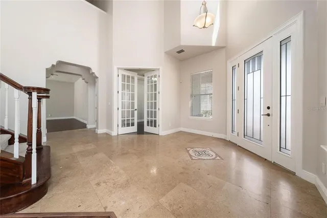 a view of wooden floor and a chandelier fan in a room