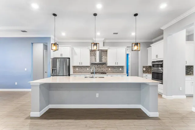 an empty room with floor to ceiling windows and wooden floor