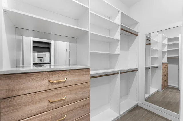 an aerial view of residential houses with outdoor space and parking