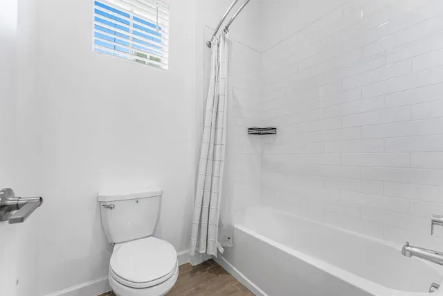 a living room with furniture a dining table and a large window