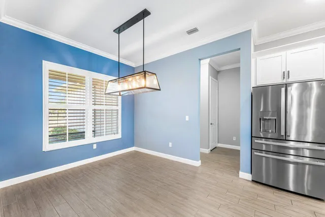 a bathroom with a toilet a sink a mirror and vanity