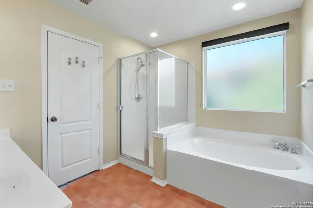 a bathroom with a bathtub and a shower